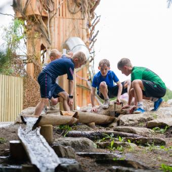 Boys playing with water streams